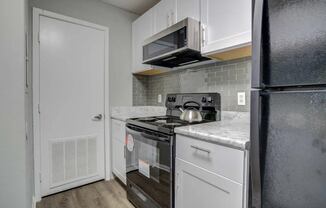 a kitchen with a stove and a refrigerator