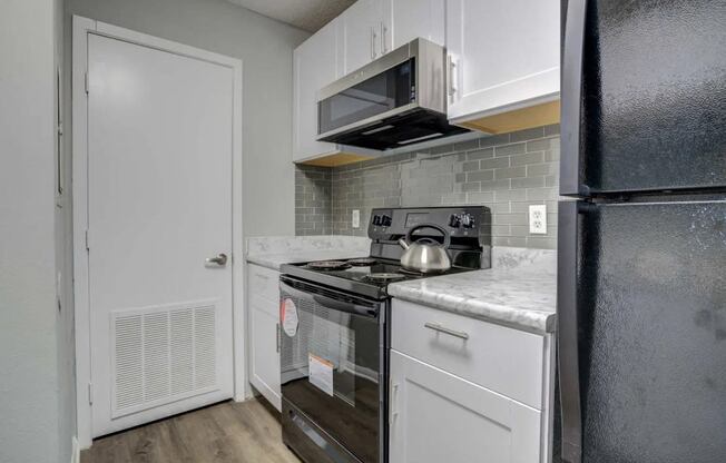 a kitchen with a stove and a refrigerator