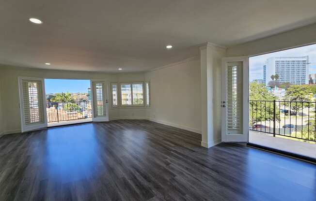 an empty living room with a view of the city