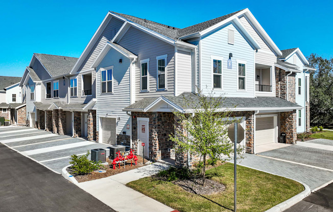 A row of houses with a clear blue sky above them.