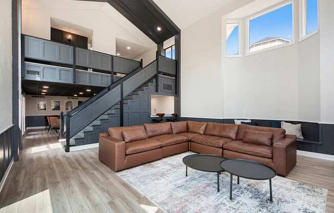 A community room with a brown couch and a black coffee table at Wingate Apartments, Kentwood