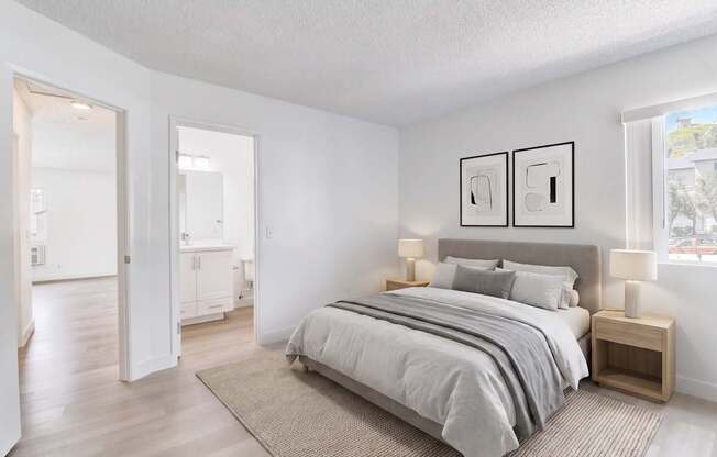 A bedroom with a large bed and two nightstands.