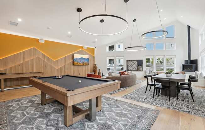 a spacious living room with a pool table and a dining room