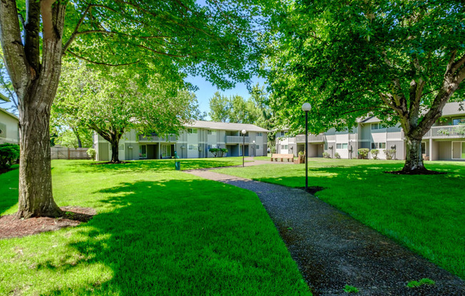 take a stroll through the grassy area at the Sequoia apartments in Springfield, Oregon