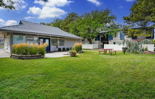 a backyard with a picnic table and a house