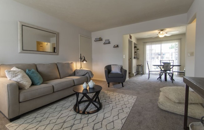 This is a photo of the living room in the 740 square foot 1 bedroom model apartment at Compton Lake Apartments in Mt. Healthy, OH.