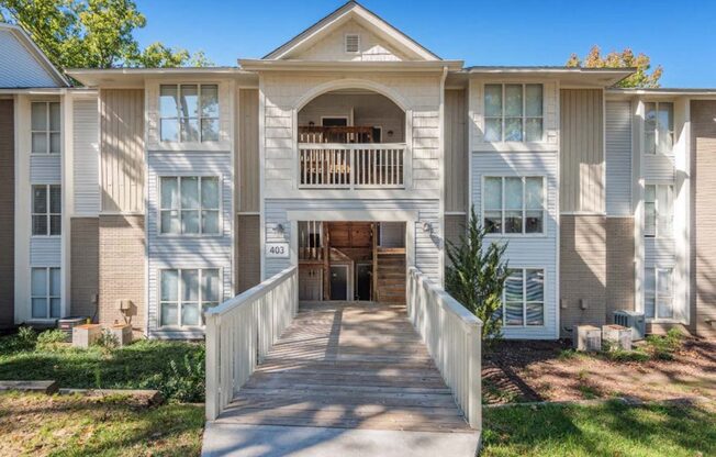 a large white house with a porch and a walkway