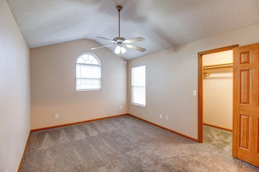 the bonus room has a closet and a ceiling fan