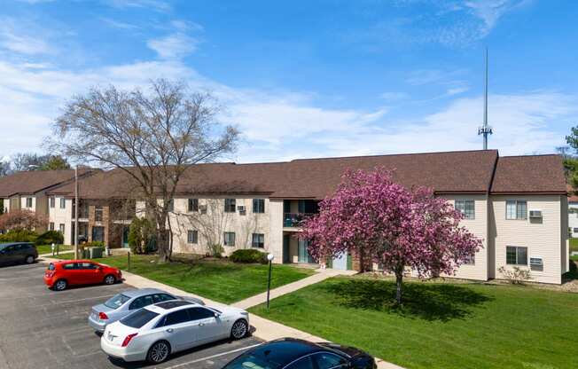 an apartment building with cars parked in front of it