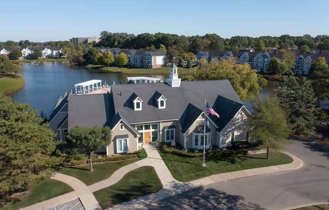 A house with a flag on the front lawn.