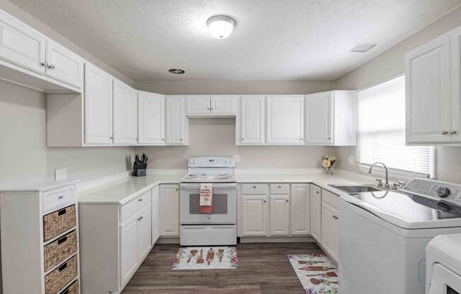 a kitchen with white cabinets and a sink and a stove at Fay Street Apartments, Winchester, 22601