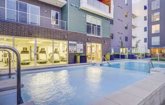 a swimming pool in front of an apartment building