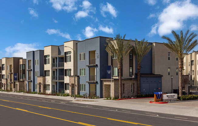 a street view of an apartment building with palm treesat Westbury Apartments, Rancho Cucamonga, California