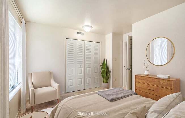 A bedroom with a bed, chair, a closet and a dresser at Irish Hills Apartments, South Bend, Indiana