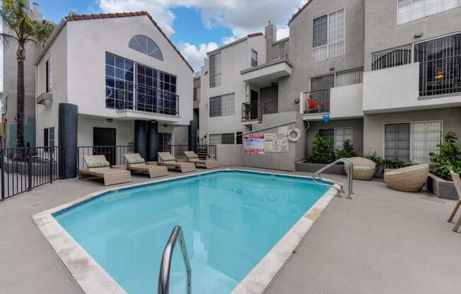 Community Swimming pool located in the middle of the apartment community with apartment buildings overlooking the pool deck.