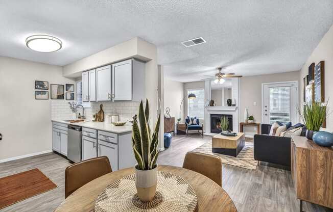 an open living room and kitchen with a table and chairs