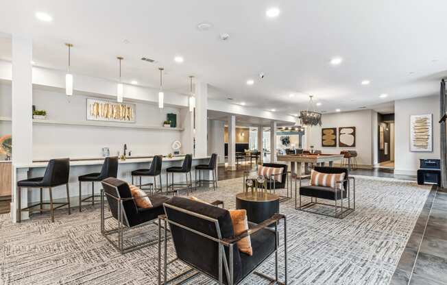 a large lobby with chairs and tables and a bar