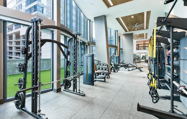A light-filled fitness studio at Modera McGavock, offering expansive training space and city views.