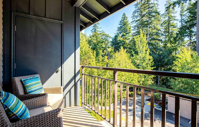 A balcony with a chair and pillow on it.