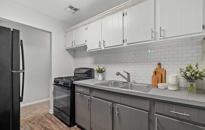 a kitchen with a sink and a refrigerator