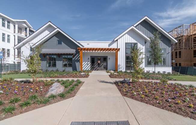 a house with a walkway and a sidewalk in front of it