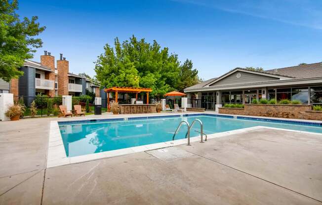 A swimming pool in a residential area with a building in the background.