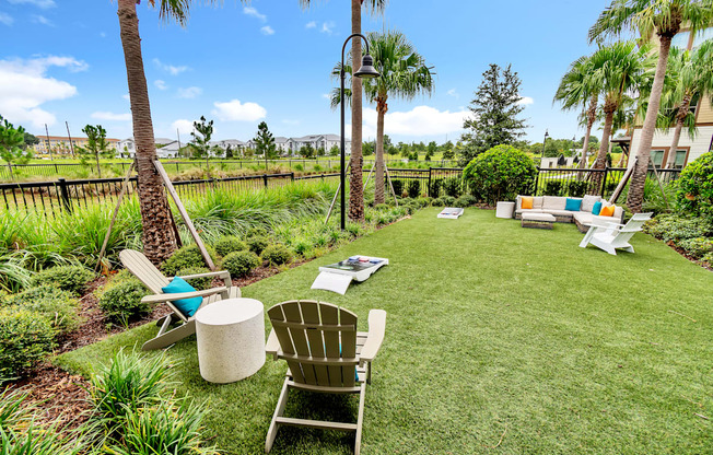 a backyard with lawn chairs and hammocks