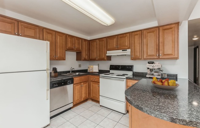 a kitchen with white appliances and granite counter tops