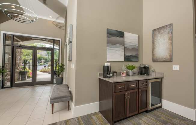 the lobby of a home with a counter and a door to a patio