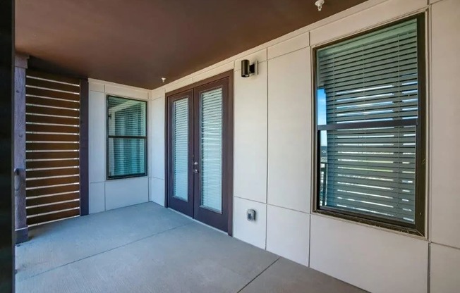 the living room of a house with windows and a patio