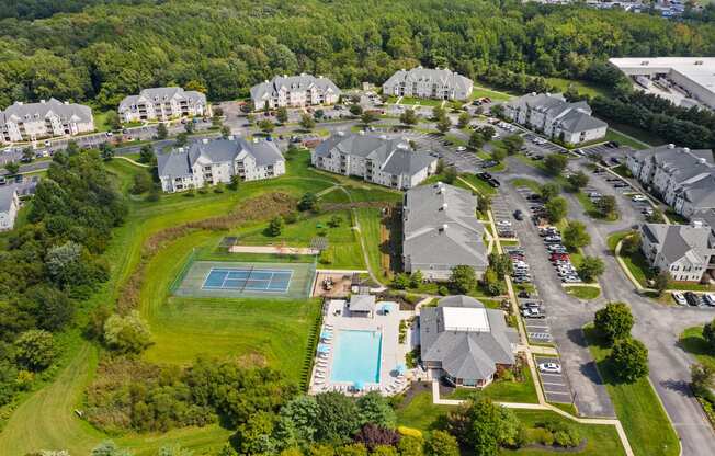 an aerial view of a neighborhood with houses and a swimming pool at The Austin Apartment Homes, Deptford, New Jersey