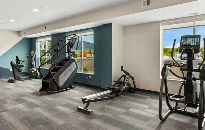 A gym with treadmills, elliptical machines, and a stair climber.