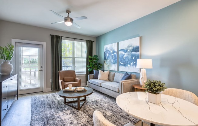 A living room with a white table and a brown chair.