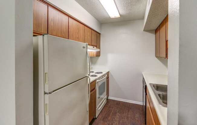 Kitchen with white appliances and lots of cabinets at Ashley Pointe Apartments