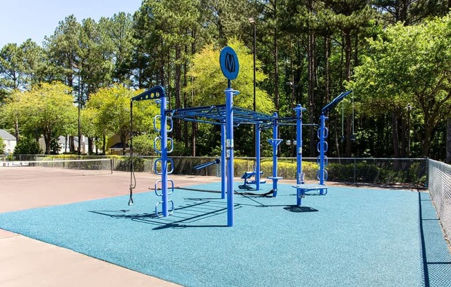 A playground with a blue swing set and a sign that says "NO" on it.