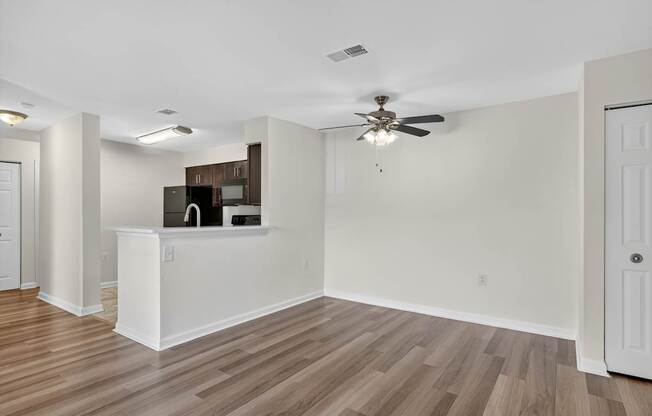 A room with a ceiling fan and a white counter.