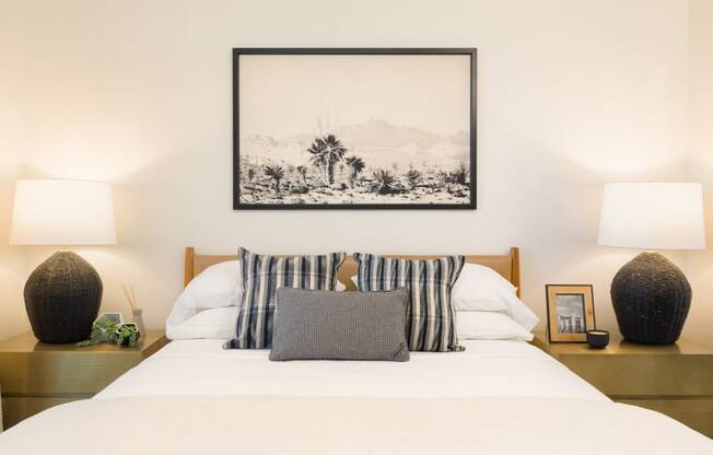 the master bedroom has a bed with white sheets and pillows