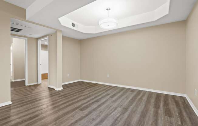 an empty living room with wood floors and a white ceiling