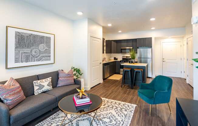 a living room and kitchen with a couch and a table