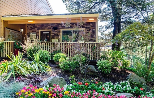 a view of the front of the house with a flower garden at The Bluffs at Mountain Park, Lake Oswego, 97035
