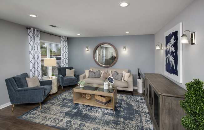 a living room with gray walls and a blue rug