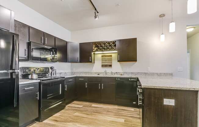 a kitchen with black cabinets and a white counter top