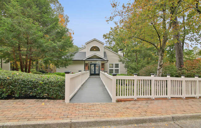 A house with a grey front door and a white fence.