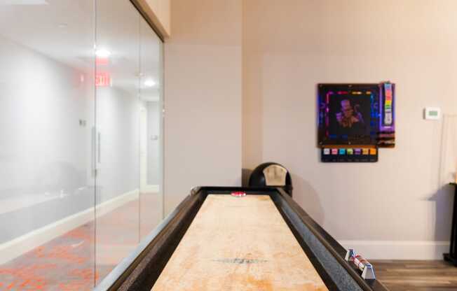 a ping pong table in a game room with a glass wall