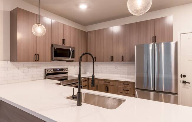 Townhouses For Rent In Raymore - Designer Kitchens With Island, Pantry, Quartz Countertops, Stainless Steel Samsung Appliances, Built-In Microwave, And Soft Close Cabinetry.