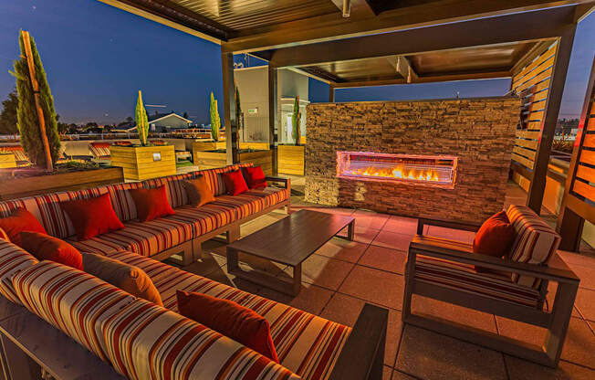 Expansive Rooftop Outdoor Fireplace And Grilling Area With Couches, Chairs, And Panoramic Views at Bayswater Apartments, Burlingame, 94010