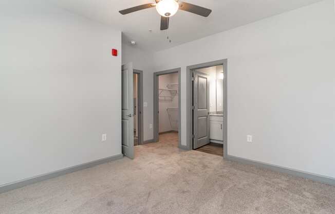 Bedroom with a ceiling fan and a closet with two doors at The Parker Myrtle Beach, Myrtle Beach, SC
