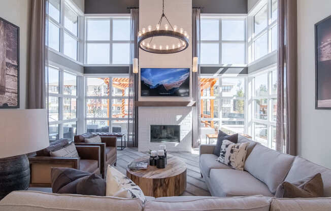 a living room with large windows and a couch and a coffee table