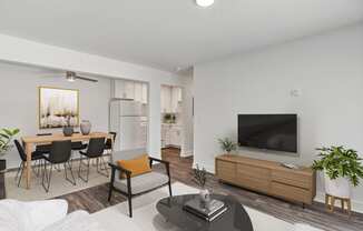 a living room with white walls and a large tv on top of a wooden cabinet