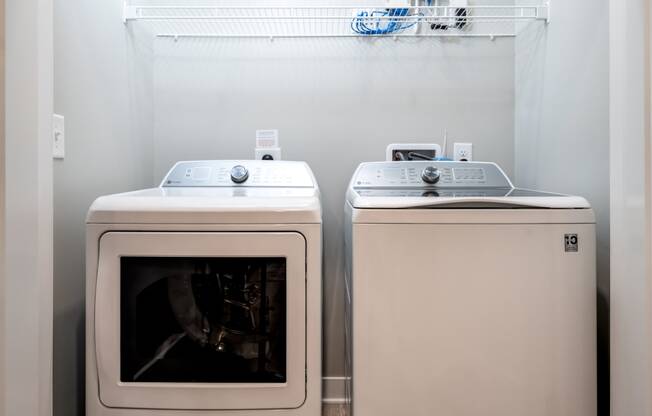 a washer and dryer sit next to each other in a laundry room